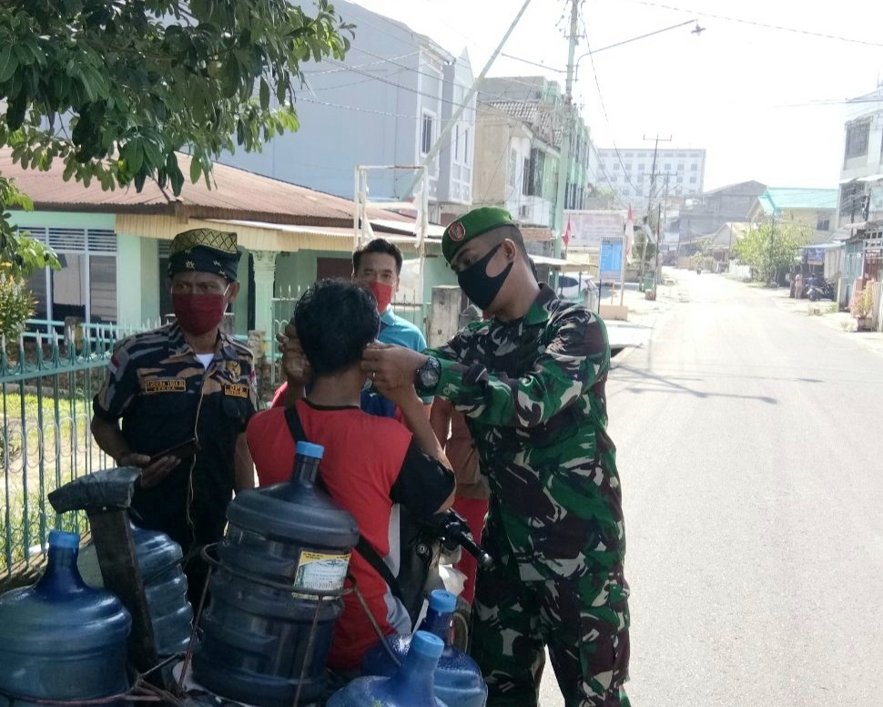 Personil Kodim 0301/PBR Sosialisasikan Protokol Kesehatan Dan Bagikan Masker Kepada Warga